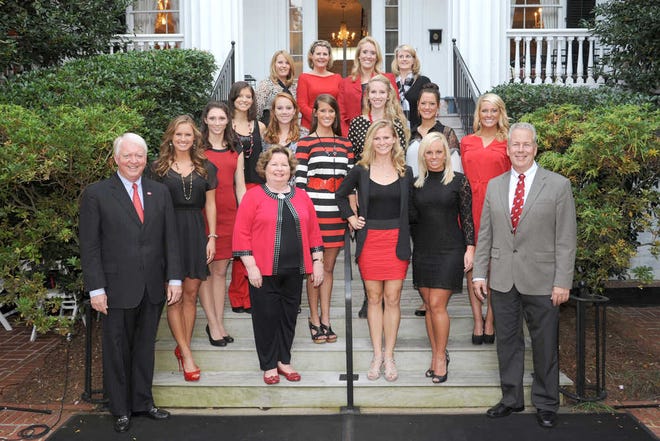 UGA President Michael F. Adams and his wife, Mary Adams, celebrate with national championship winning UGA majorettes at a reception in October. The majorettes, a part of the university's Redcoat Marching Band, were named the 2012 Collegiate Halftime Show Twirl National Champions and Collegiate National Halftime Champions at the America's Youth on Parade USA and World Twirling Championships in South Bend, Ind., in July. Photo by Wingate Downs
