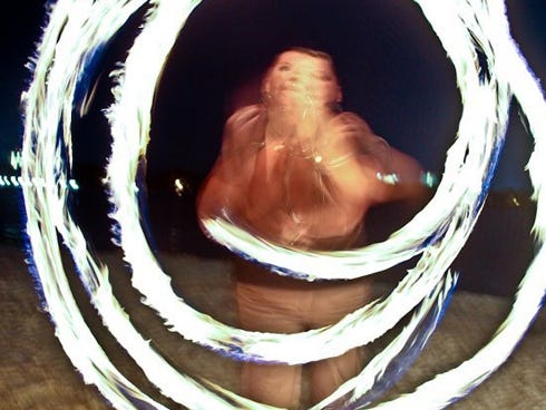 Great balls of fire – Ussery spins Poi over her head during a show.