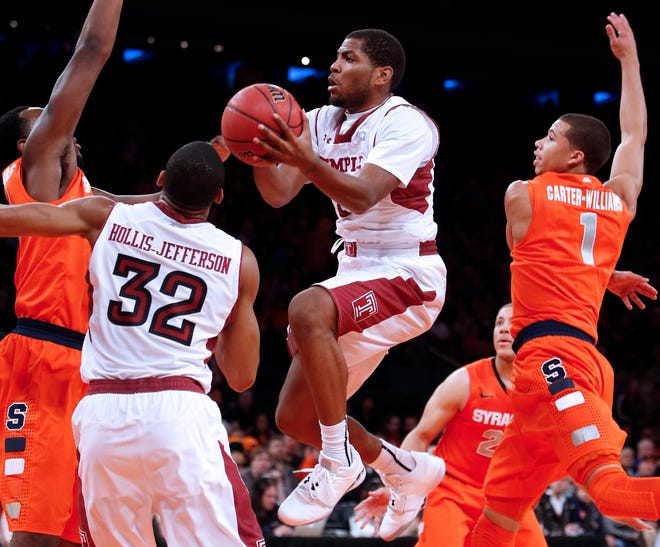 Temple's Khalif Wyatt shoots against Syracuse's Rakeem Christmas, left, and Michael Carter-Williams (1) during the first half of an NCAA college basketball game in the Gotham Classic tournament at Madison Square Garden, Saturday, Dec. 22, 2012, in New York. Temple defeated Syracuse 83-79. (AP Photo/Jason Decrow)