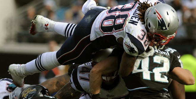 New England running back Brandon Bolden dives over the pile short of the goal line during the second half of Sunday's game against Jacksonville. The Patriots later scored on that drive and held on to beat the Jaguars, 23-16.