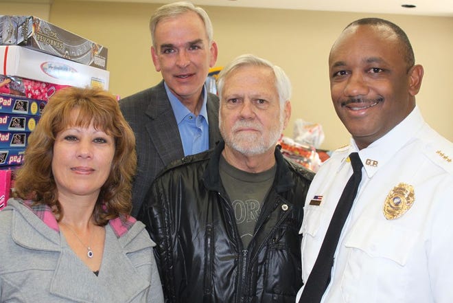 The Gonzales Police Dept. teamed up with Needy of Greater Baton Rouge to collect a room full of toys for area children this Christmas. Shown are Tracey and Tim Arceneaux, Tim Couret, and Gonzales Police Chief Sherman Jackson.