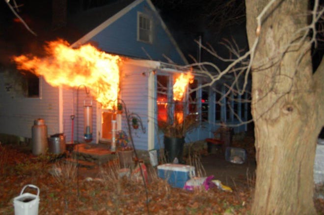 Flames pour out of a porch at the home at at 43 Cordaville Road when firefighters arrived at about 5:30 p.m. Saturday.
