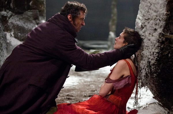 This film image released by Universal Pictures shows Hugh Jackman as Jean Valjean, left, and Anne Hathaway as Fantine in a scene from "Les Miserables."