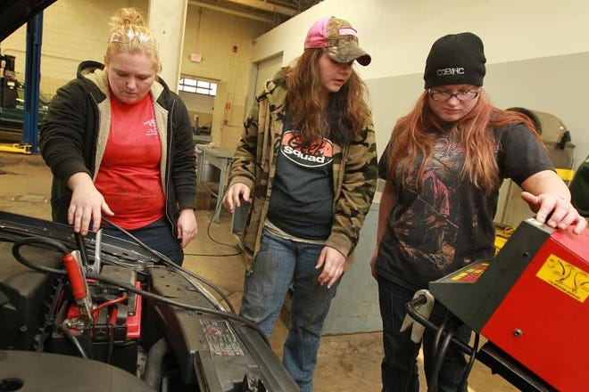 (L-R) Kandice Shedd, Nicole Hill and Angel Griffin test the battery in a VW Tuesday morning, December 11, 2012 in the automotive garage at the Pharr Building on the campus of Gaston College in Dallas.
