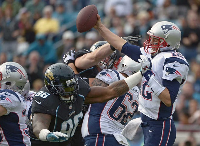 Patriots quarterback Tom Brady tries to evade some defensive pressure from Jacksonville's Terrance Knighton during the first half of Sunday's 23-16 New England win.