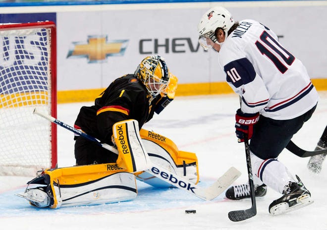 Team USA forward J.T. Miller, right, scores past Germany goalie Marvin Cupper in the third period Thursday at the world junior ice hockey tournament in Ufa, Russia. The U.S. won, 8-0.