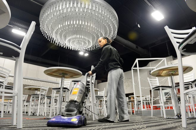 Bree Pollard vacuums the carpet in the main room at World Famous Big Al's, the Peoria cabaret that moved from its Main Street location after four decades to a new building on Southwest Jefferson Avenue. The building has a 15,000-square-foot main floor.