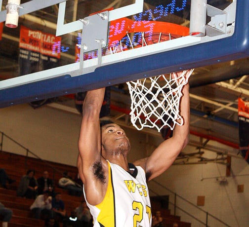 Joliet West's Morris Dunnigan dunks home two of his 12 points in the Tigers' PHT win over Niles West Thursday.