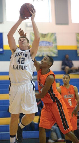 Western Alamance's Hunter Lent puts up a shot in front of Orange's Brandon Frye in Wednesday's first boys' game.