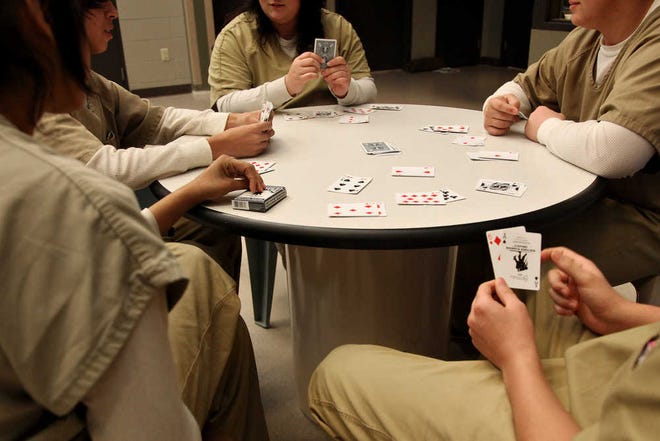 Inmates at the Youth Center of the High Plains play Go Fish on Friday afternoon. The number of incarcerated youth in Texas has dropped by more than two-thirds in the past five years.