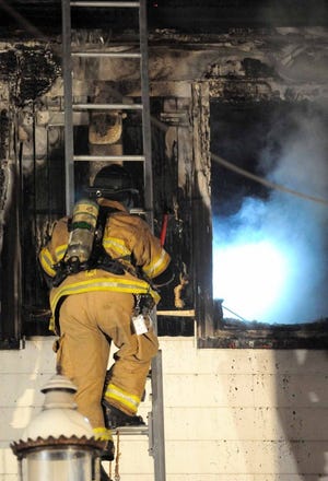 Firefighters work to clear a fire in a home at 200 Union Avenue in Delanco on Thursday evening.