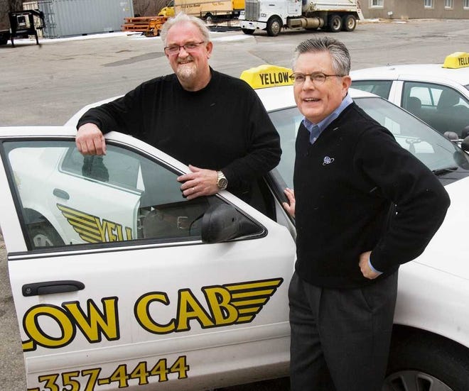 Chris Avey, left, Yellow Cab Co. and James Hanni, AAA spokesman announced the New Year's Eve "Care Cab" rides during a news conference Friday. The "Care Cab" rides are sponsored this year by AAA, Yellow Cab Co., and the Law office of Swinnen and Associates.
