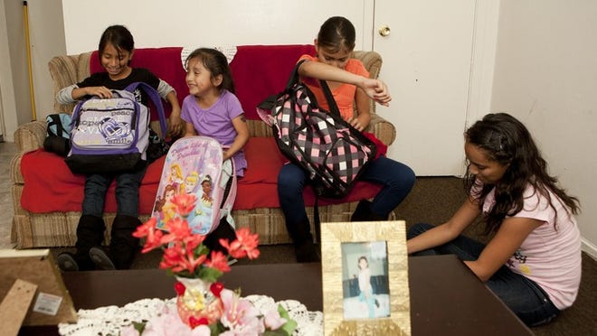Yari, 10, left, Roxanna, 5, Jovana, 11, and Maria Rosas, 12, arrive at home and begin working on their homework. Their mother, Juana Rosas, is single mother of five children living in a one-bedroom apartment and barely able to make ends meet.
