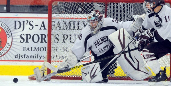 Falmouth goalie Cody Garcia stops a Chelmsford shot with Storm Fotiu by his side in Friday's Cape Cod Cup at Falmouth Ice Arena. The teams played to a 2-2 tie.