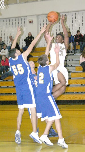 Herschel Ivey puts up a shot for Ilion Saturday with Mt. Markham Mustangs Tyler Ostrander (55) and Mike Alsante defending.