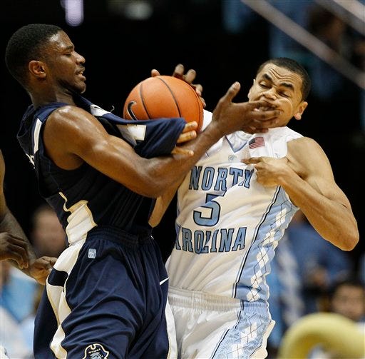 North Carolina's Marcus Paige gets slapped in the face by East Tennessee State's Rashawn Rembert in a game earlier this month.