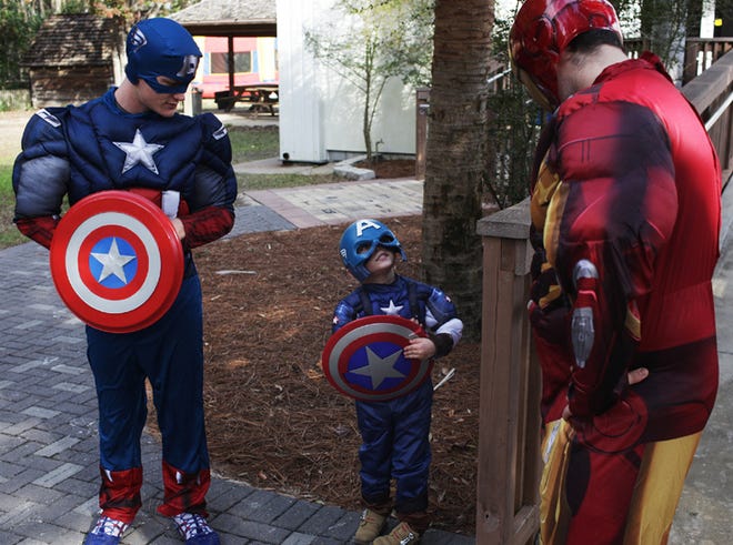 Zane Turnipseed, left, and Dillon Ma Mont, right, talk with Timothy Trujillo, 5, during the first annual superhero day at the Science and Discovery Center Saturday.
