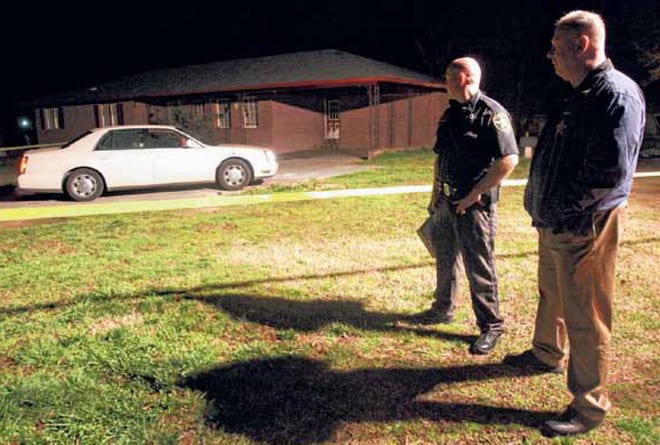 Cleveland County Sheriff Alan Norman, right, talks with Deputy James Ellis at the scene of a shooting where Francis Kwasi Munufi, 38, was killed outside a vacant home at 204 Putnam Place in Kings Mountain in March. (Star file photo)