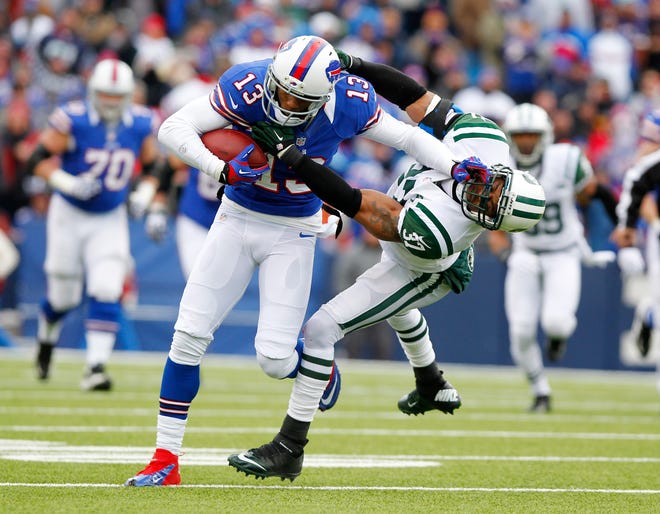 Buffalo Bills wide receiver Stevie Johnson (13) pushes off New York Jets strong safety Yeremiah Bell (37) during the first half of an NFL football game on Sunday, Dec. 30, 2012, in Orchard Park, N.Y.