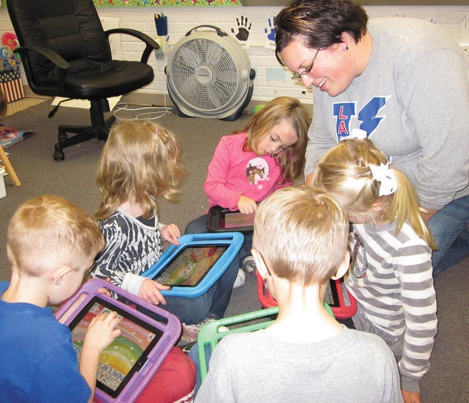 Morgan Joyce, Mrs. Dills, Allyson Duvall, Ava Collins, Ryan Anderson and Adam Hess use iPads to create words. This app even reads the words created or it can give the student a word to spell. Melissa Dills is this month’s featured teacher. story on page 13