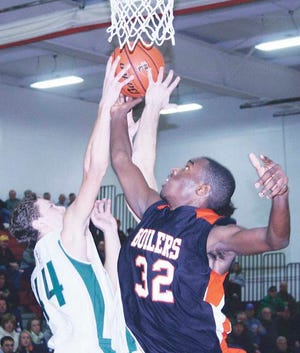 Donovan Oliver of Kewanee (32) and Brad Groleau of St. Bede (44) battle for a rebound during the Marseilles Holiday Tournament championship game Saturday night.