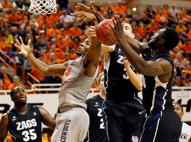 Oklahoma State's Marcus Smart (33) loses the ball against Gonzaga's Kyle Dranginis (3) and Guy Landry Edi (10) as Sam Dower (35) looks on during a men's college basketball game between Oklahoma State University (OSU) and Gonzaga at Gallagher-Iba Arena in Stillwater, Okla., Monday, Dec. 31, 2012. Photo by Nate Billings, The Oklahoman