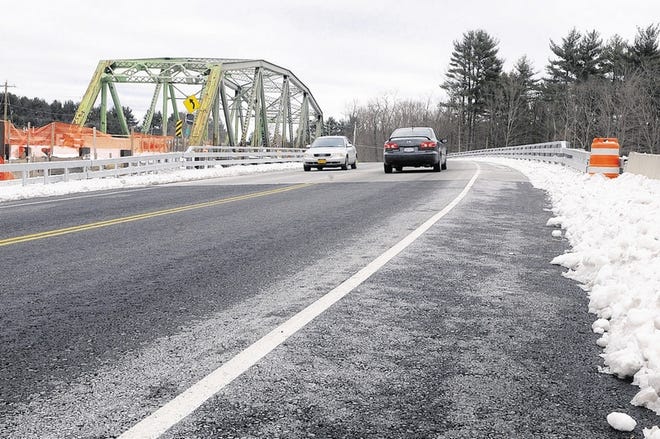Vehicles travel over the new bridge on Route 209 in Cuddlebackville. It replaces the old span, at left, which was built in 1928 and will soon be torn down. The bridge project, paid for largely with federal money, also includes a new parking area that will offer recreational access to the Neversink River.