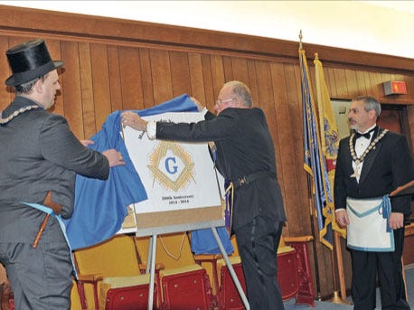Submitted Photo - From left, Worship Master Dwayne Dolly II, MW Brother Robert E. Feilbach, chairman of the 200th Anniversary Committee, Michael Iannitelli, PM, unveil the Mansfield Lodge 200th anniversary logo.