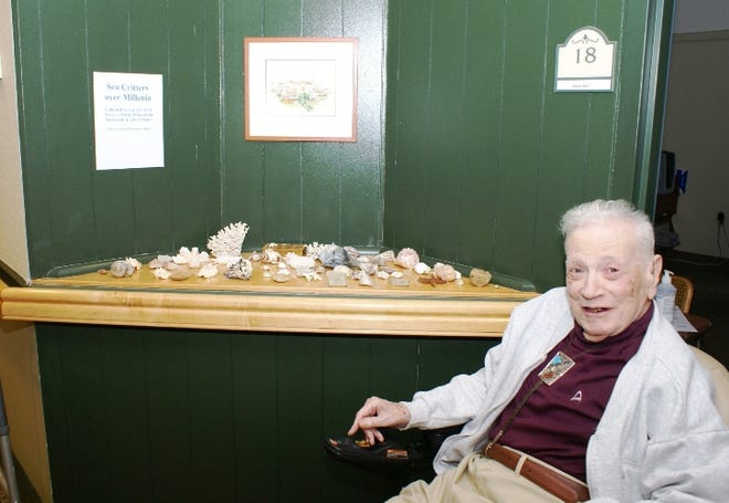 Foulkeways resident, Dr. Gus Beck, in front of his collection of Sea Critters and Fossils.