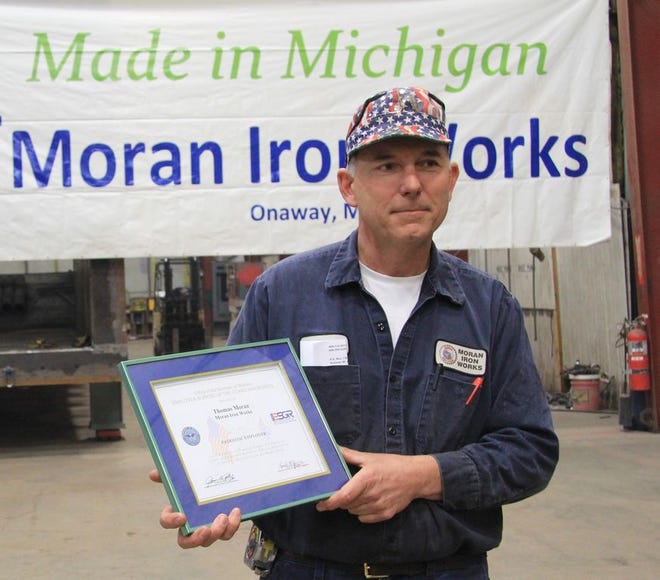 Tom Moran pictured with the award he received Friday for his support of an employee who is serving in Afghanistan.