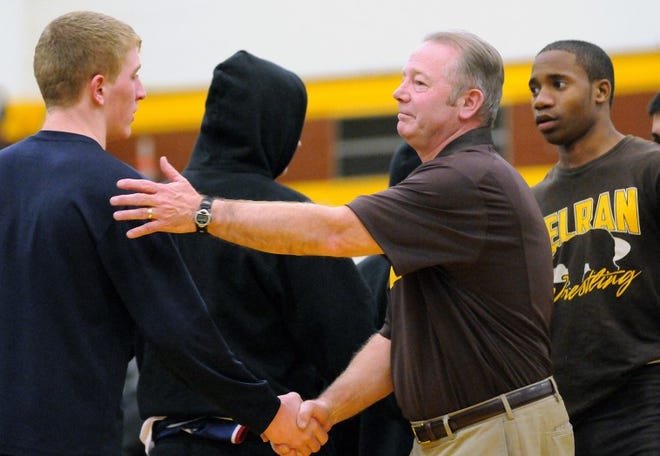 Delran High School wrestling coach Dennis Smith shakes the hands of players after their match on Wednesday night at Delran High School