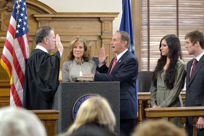 Congressman Chris Collins, middle, gets sworn in at the Ontario County Court House in Canandaigua.
