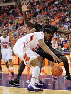 Clemson's Devin Booker attempts to drive past Florida State's Michael Ojo Saturday during the first half.