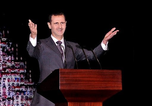 Syrian President Bashar Assad, speaking Sunday in Damascus, outlined a new peace initiative that includes a national reconciliation conference and a new government and constitution but demanded regional and Western countries stop funding and arming rebels first.