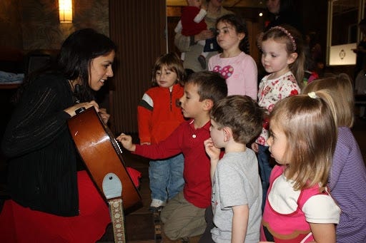 Children from the MOMS Club of Yardley celebrate the holidays with Bucks County signer/songwriter Meg Russell at McCaffrey’s in 2011.