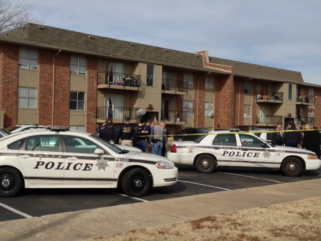 Police gather at the scene of a multiple homicide at the Fairmont Terrace apartment complex in Tulsa on Monday. MATT BARNARD/Tulsa World