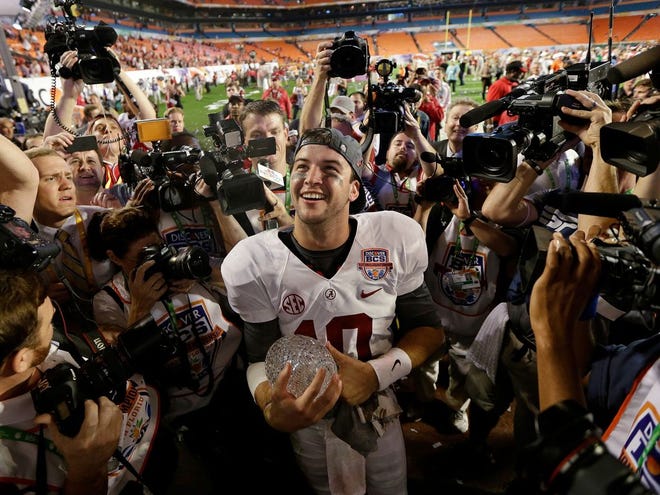 Alabama's AJ McCarron holds the Coaches' Trophy after the BCS national championship game against Notre Dame Monday, Jan. 7, 2013, in Miami. Alabama won 42-14. (AP Photo/David J. Phillip)