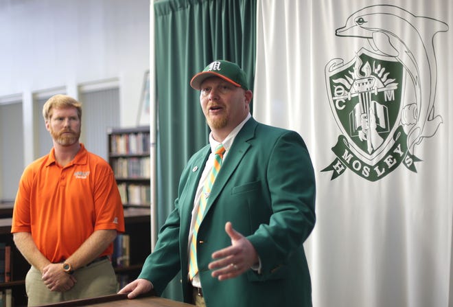 New Mosley coach Jeremy Brown is introduced as Athletic Director Danny Nagy looks on.
