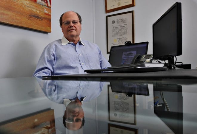 Stewart Paul, president of TeamLogic IT in Newtown, sits in his office on State Street in Newtown Borough Friday.