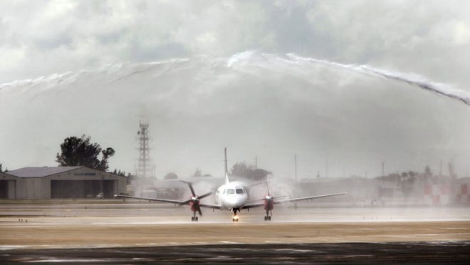 Palm Beach International Airport on Tuesday welcomed some of the first passengers to arrive from Tampa International Airport via two new nonstop daily flights on Silver Airways. The arrival of the flight into PBIA at 12:30 p.m. was greeted with water cannons on the runway. (Bruce R. Bennett/The Palm Beach Post)
