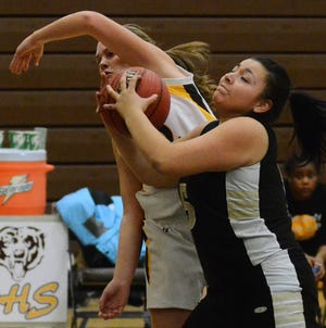 First quarter action in Tuesday night's BCSL girls basketball game had Burlington Township's 5 Daniella Munoz grabbing the rebound from Delran's 32 Nicole Bayer.