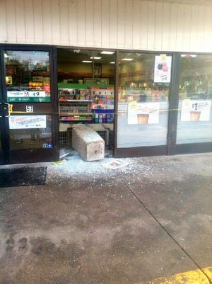 A cement trash can crashes into the front of the Centerville 7-Eleven store Tuesday afternoon after a car slammed into it.