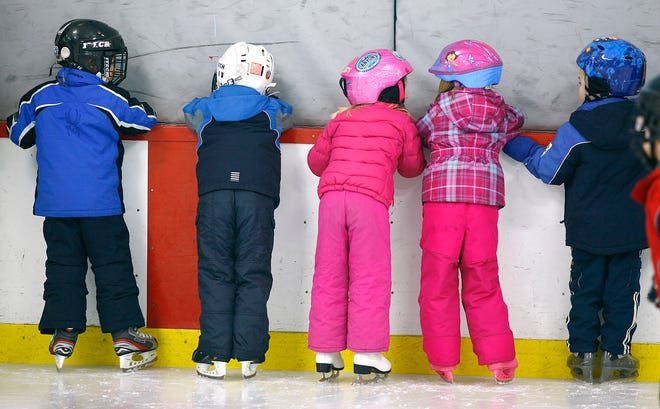 Children in the Tiny Blades class at Pilgrim Skating Arena in Hingham learn that when first trying to skate, the railing is your friend.