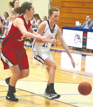 Inland Lakes' senior guard Sandy Bischoff (right) looks to dribble past Johannesburg-Lewiston's Katelyn Weaver during their contest in Indian River on Wednesday night.