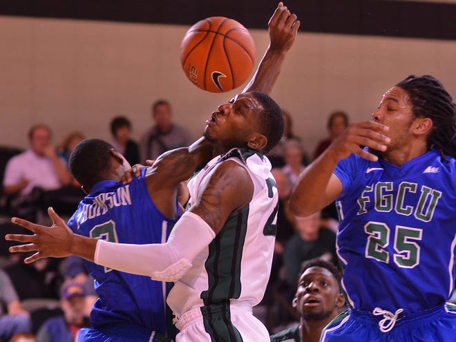 USC Upstate's Torrey Craig, middle, battles for a loose ball with Florida Gulf Coast's Bernard Thompson and Sherwood Brown (25) on Thursday night at USC Upstate.