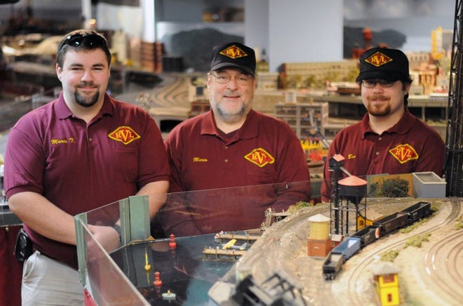 Mario Leone Sr. (center) of the Burlington County Model Railroad Club, with sons Mario Leone Jr. (left) and Benjamin Leone, in their club's layout in the basement of Footlighters on Pomona Road in Cinnaminson.