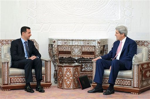 FILE - This April 1, 2010 file photo released by the Syrian official news agency SANA, shows Syrian President Bashar Assad meeting with Sen. John Kerry, D-Mass., President Barack Obama's choice to become the next secretary of state, at al-Shaab presidential palace in Damascus, Syria. Kerry's past words of encouragement for Syrian President Bashar Assad are certain to draw scrutiny at his confirmation hearing for secretary of State as the Mideast ruler's brutal crackdown has plunged the country into months of deadly civil war and turned Assad into a pariah.