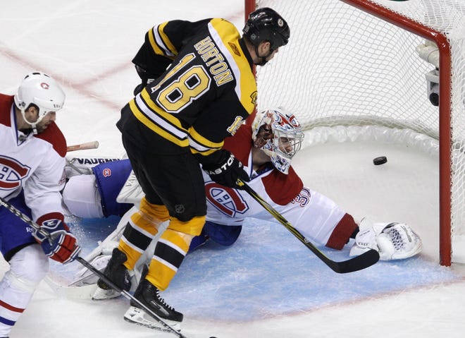 Bruins right wing Nathan Norton (18) beats Montreal Canadiens goalie Carey Price for the game-winning goal during the second overtime period in Game 5 of a first-round NHL Stanley Cup hockey playoff series in Boston last night.