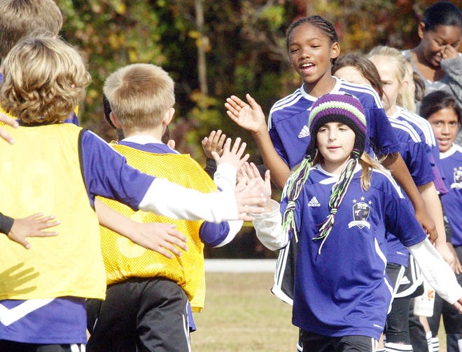 Players slap hands after a Havelock Youth Soccer Association match at the Havelock Recreation Facility. Association officials, along with other youth league officials, say the facility off Fontana Boulevard simply isn't big enough to handle all children playing various sports in the city.