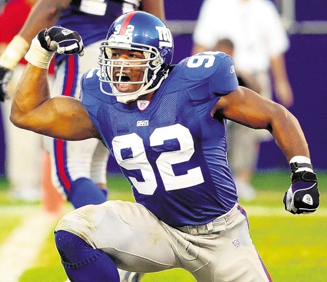 FILE - In this Sept. 22, 2002, file photo, New York Giants defensive end Michael Strahan celebrates after sacking Seattle Seahawks quarterback Trent Dilfer during the third quarter of an NFL football game at Giants Stadium in East Rutherford, N.J. Single-season sacks leader Strahan and two players who tried to block him are among 15 modern-era finalists for the Pro Football Hall of Fame, the hall announced Friday, Jan. 11, 2013. (AP Photo/Bill Kostroun, File)